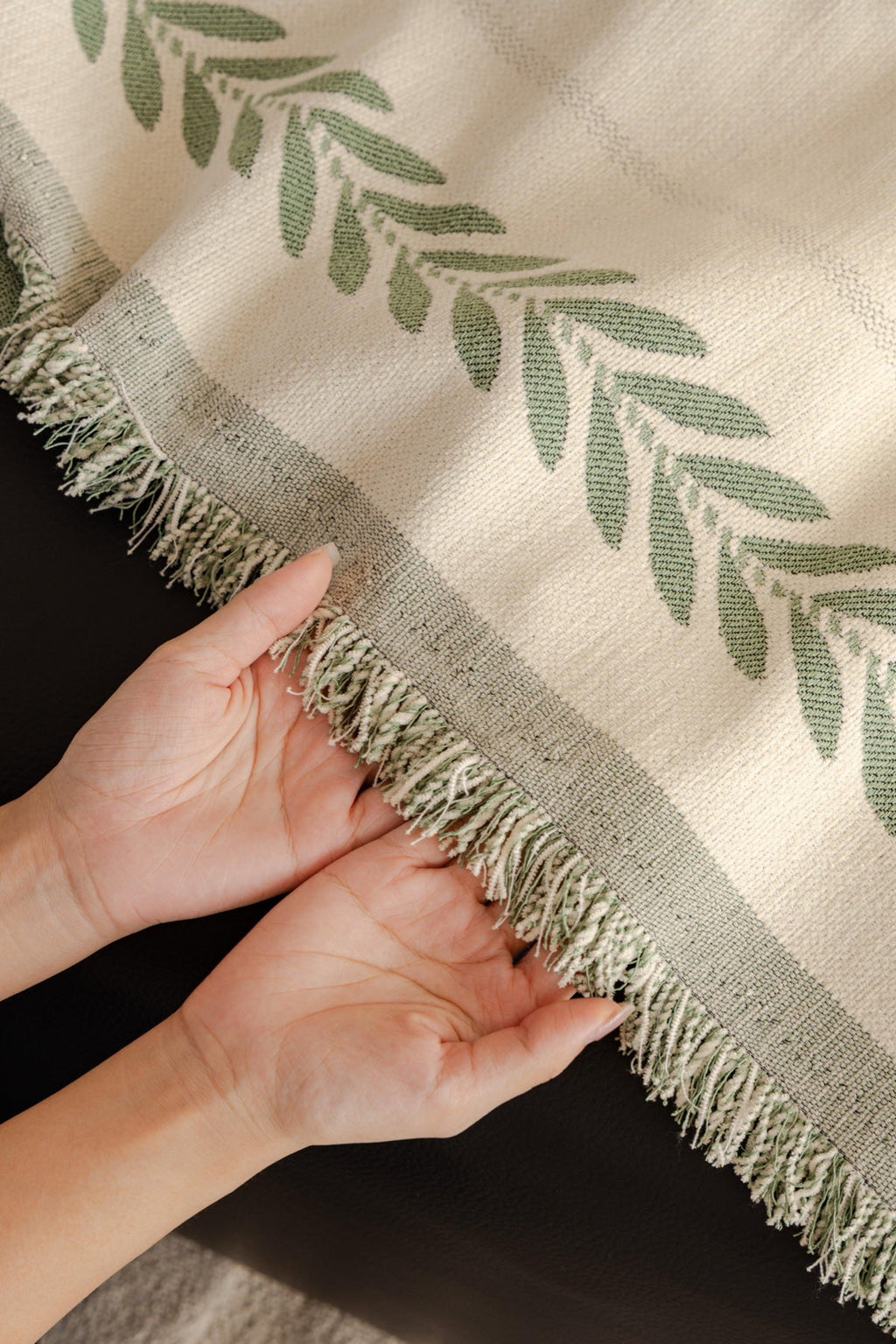 Decor Cedar Elowen Olive Border Sofa Throw Cover in Olive Border - olive border sofa throw cover hand and drape closeup in United States, image 14